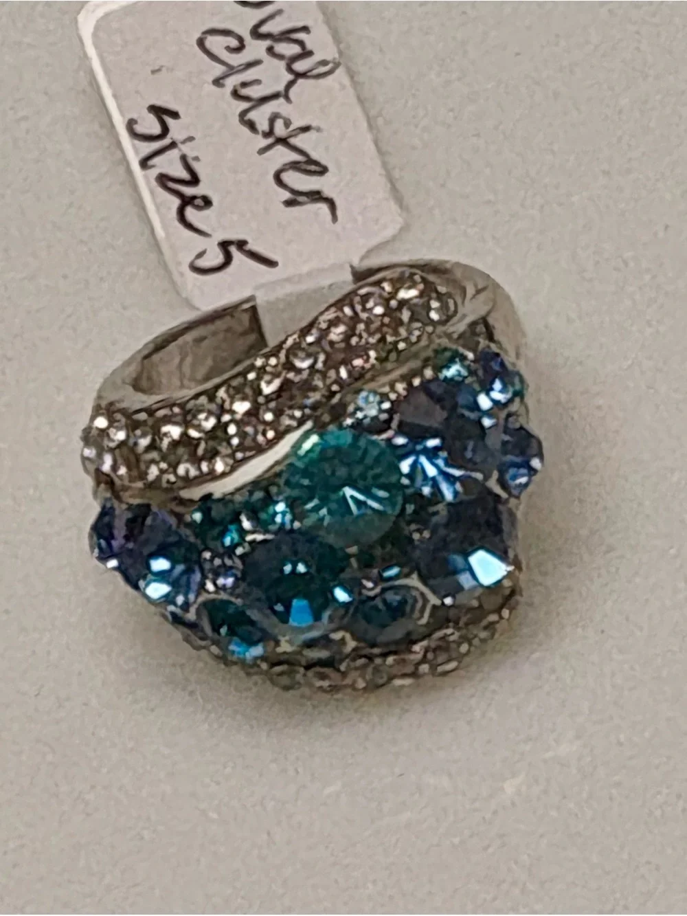 Silver tone statement ring w/sparkling blue & teal crystal cluster.Size 5 & 5.5